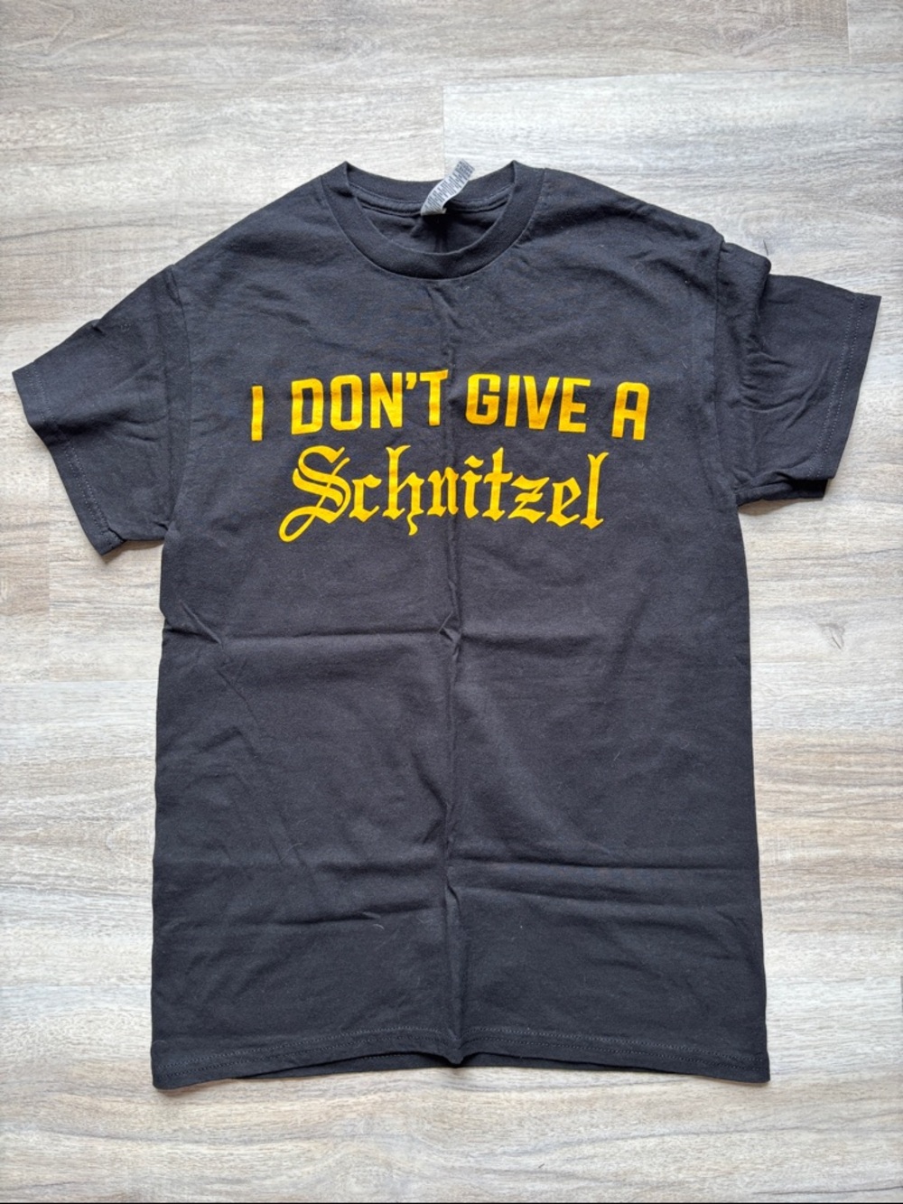 Gildan NWOT Small Black Tee with Yellow "I Don't Give A Schnitzel" Graphic